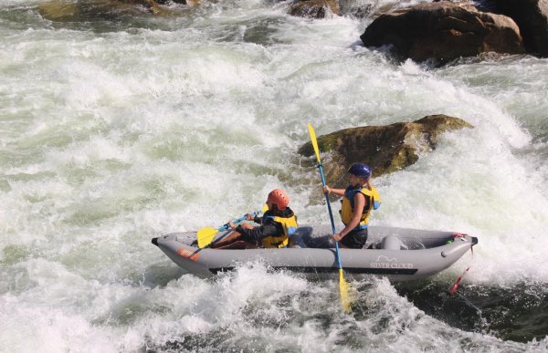 double kayak in a rapid